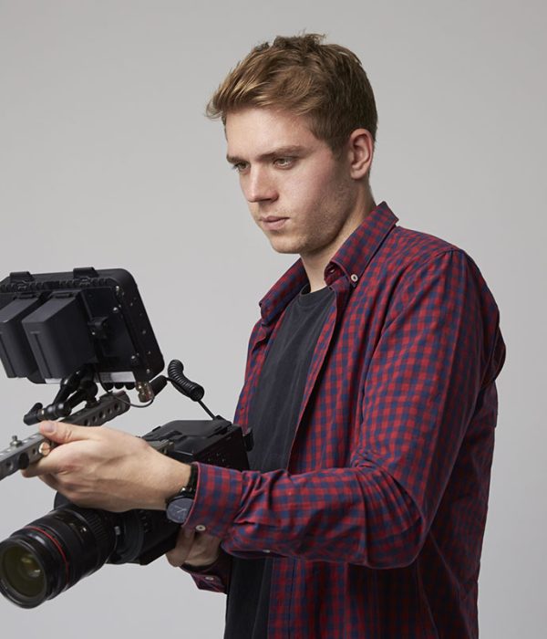 studio-portrait-of-male-videographer-with-film-cam-2021-08-26-16-12-59-utc-copy.jpg